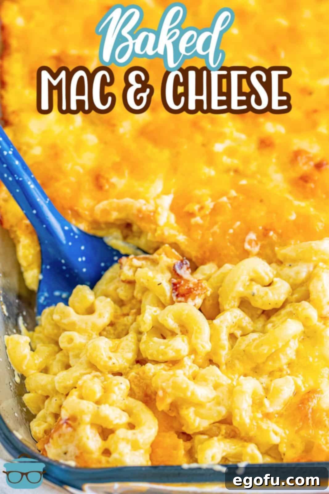 Golden Crusted Macaroni 3 A beautiful baking dish filled with golden-brown baked mac and cheese, with a blue serving spoon ready to scoop.