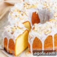 Southern Crunch Delight 13 A close-up view of a Louisiana Crunch Cake, with a slice being removed, highlighting its texture and glaze.