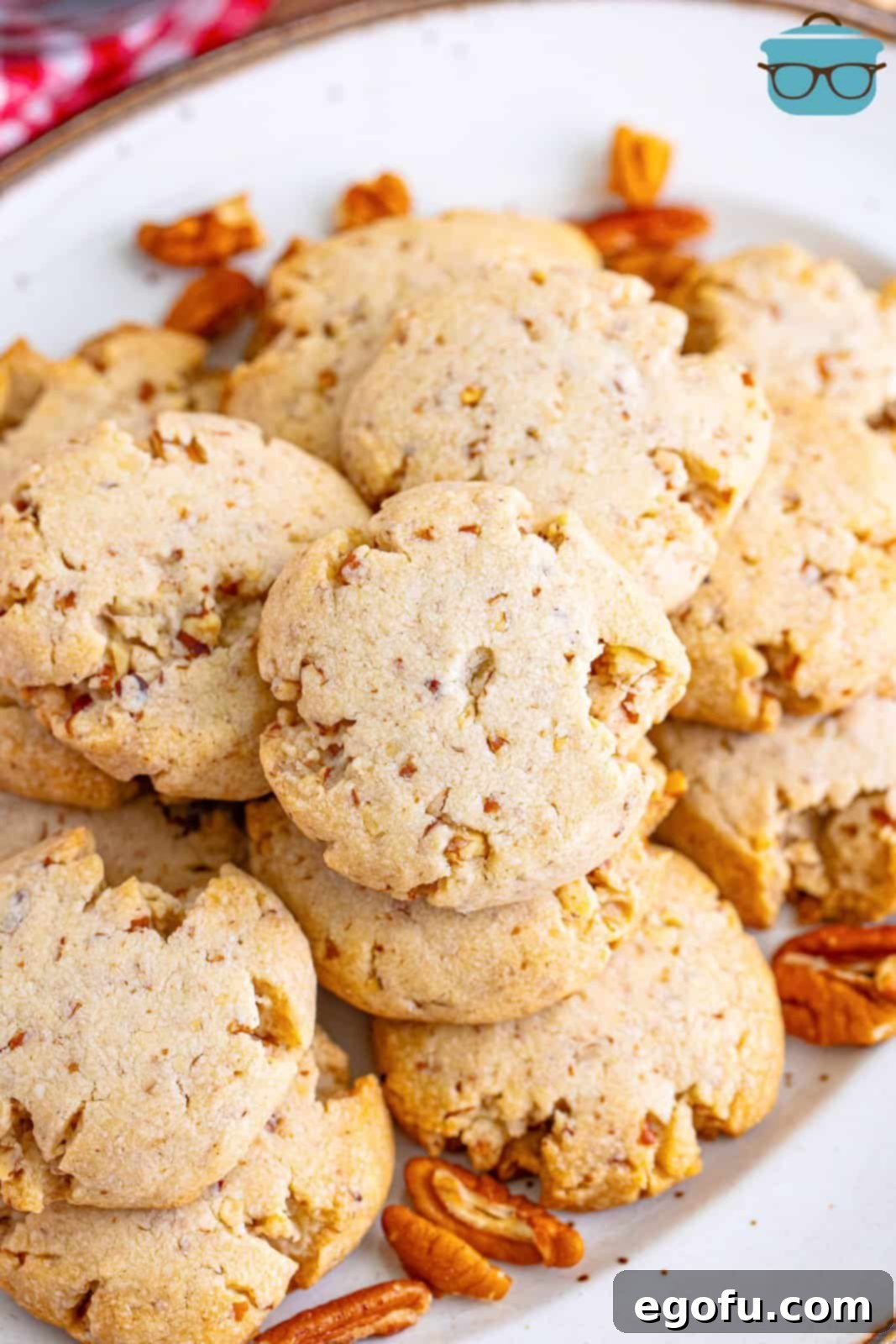 A bountiful plate overflowing with freshly baked Pecan Sandies, inviting you to indulge in their warm, nutty goodness.