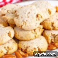 A collection of perfectly baked Pecan Sandies elegantly arranged on a plate.