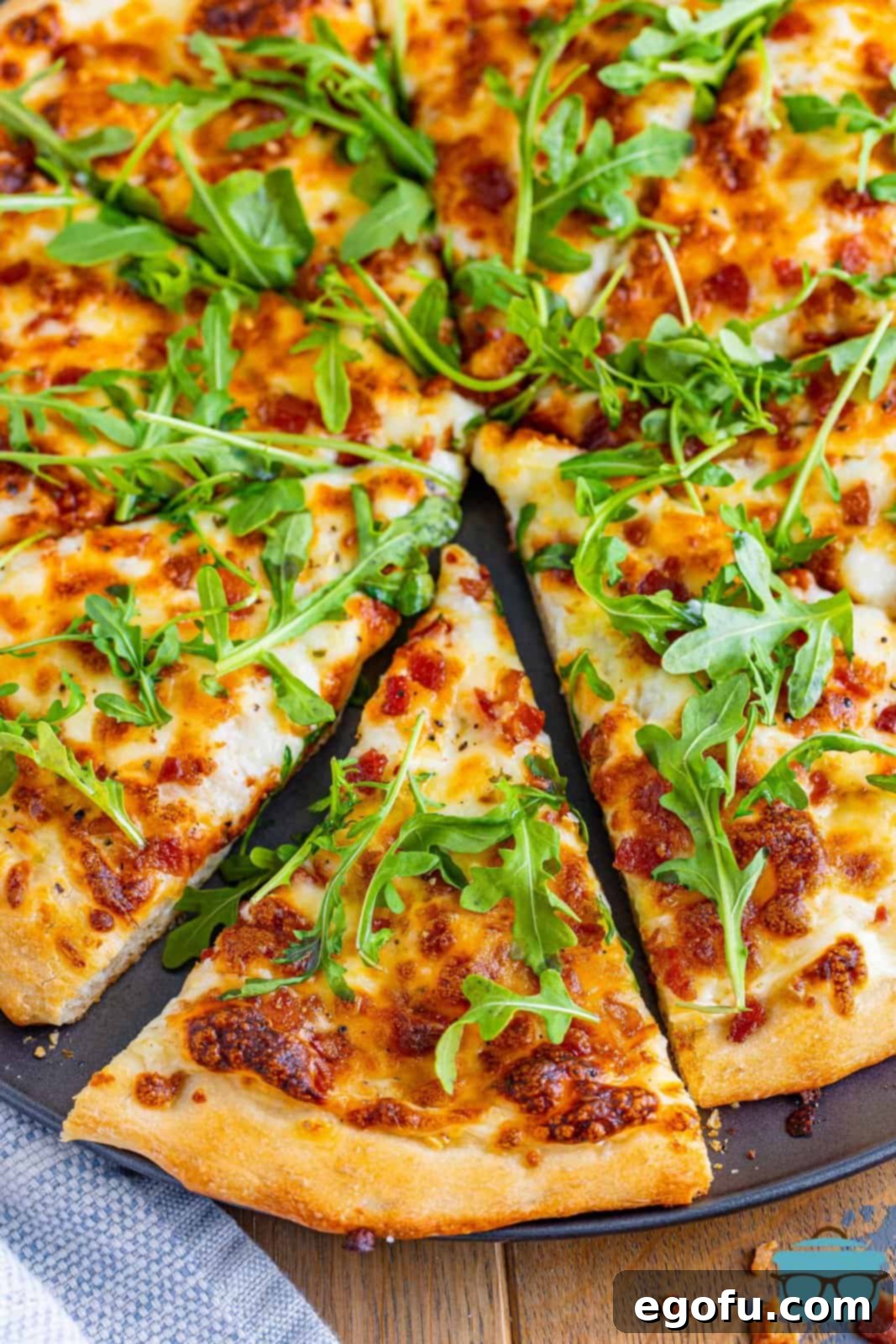 Looking down on a copycat White Top Blaze Pizza with a slice being removed.