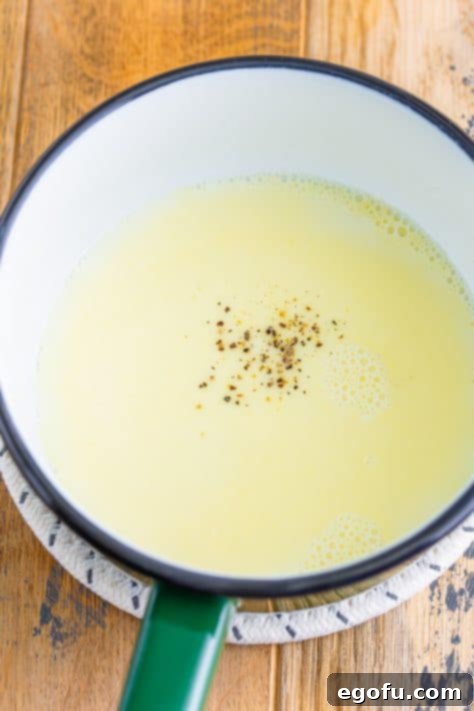 Garlic, butter, milk, salt and pepper, and flour in a saucepan.