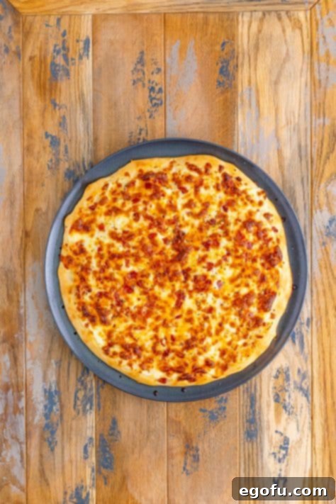 A baked blaze pizza on a pizza pan.