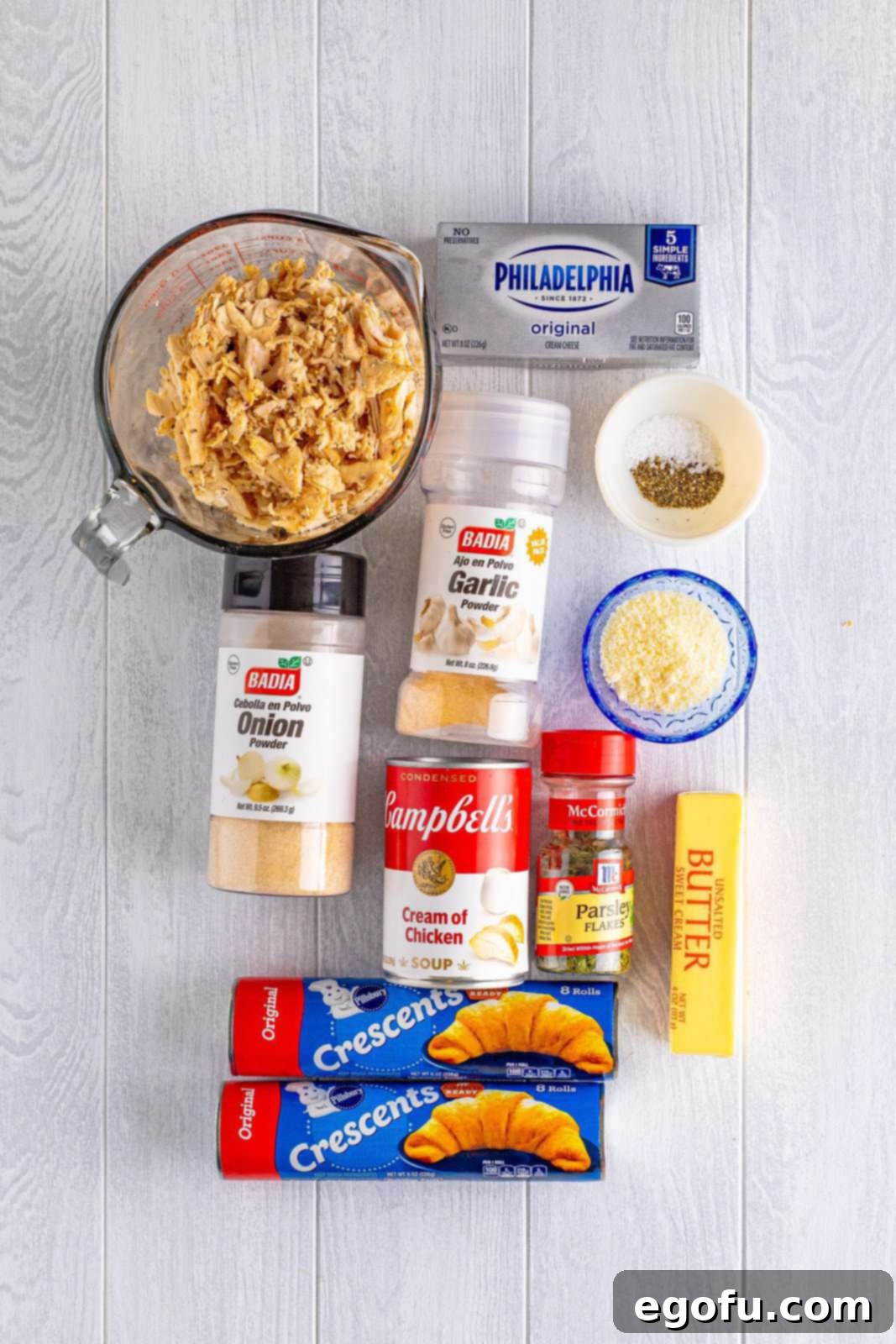 Savory Chicken Pockets 4 Rotisserie chicken, onion powder, garlic powder, cream cheese, cream of chicken soup, grated parmesan cheese, dried parsley, black pepper, kosher salt, butter, and crescent roll dough.