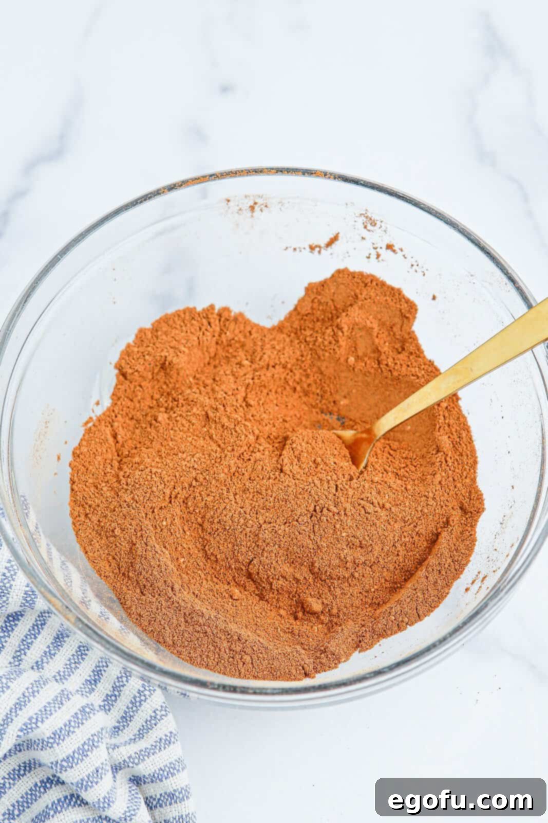 A mixing bowl filled with the freshly combined homemade Apple Pie Spice, ready for use.