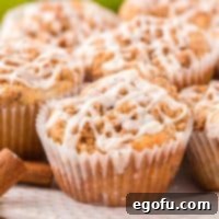 Close up looking at a few Apple Muffins, highlighting the streusel and glaze.