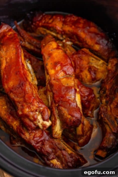 Tender Slow Cooker BBQ Country Style Ribs 15 BBQ Ribs cooking in a slow cooker.
