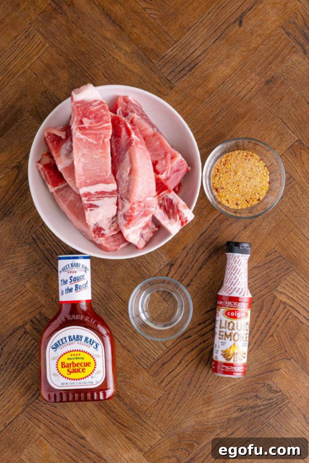 Tender Slow Cooker BBQ Country Style Ribs 4 BBQ sauce, bone in country style ribs, garlic powder, red pepper flakes, paprika, black pepper, mustard powder, salt, brown sugar, water, and liquid smoke.