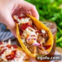 Down-Home Tacos 12 A Hillbilly Taco being held above others, showing its delicious filling.