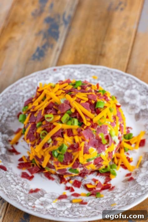 Savory Beef Cheese Delight 15 Cheese ball covered in cheese, green onions, and dried beef.