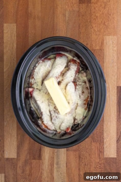 Fall-Apart Tender Mississippi Country Ribs 11 Ribs with seasoning and a stick of butter in a slow cooker.