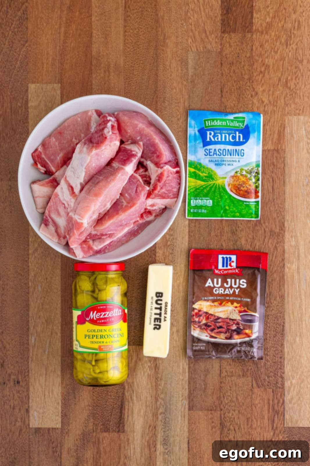 Fall-Apart Tender Mississippi Country Ribs 4 Country style ribs, ranch mix, au jus gravy mix, butter and pepperoncinis. All raw ingredients laid out before cooking.