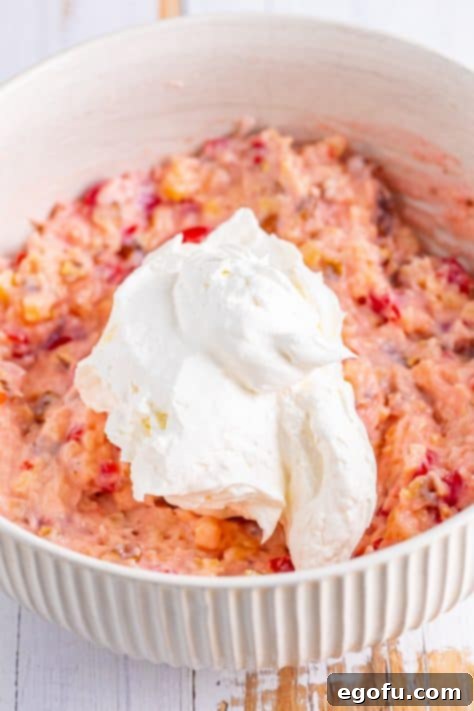 Whipped topping on the rest of the pie ingredients in a mixing bowl.