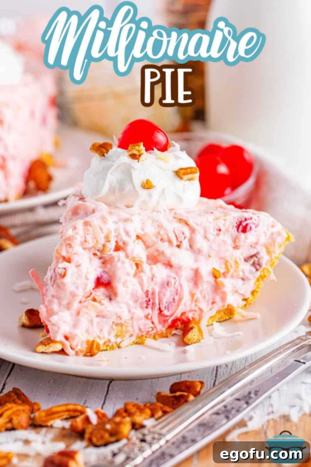 A vibrant slice of Millionaire Pie adorned with a dollop of whipped topping and a cherry, resting on a white serving plate.