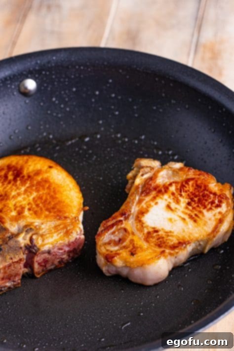 Soulful Mississippi Slow Cooker Pork 12 Seared pork chops in skillet, browning beautifully.