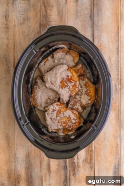 Soulful Mississippi Slow Cooker Pork 14 Crock pot with pork chops and au jus gravy mix sprinkled over.
