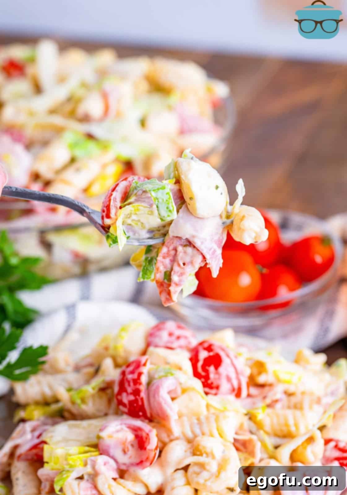 Spoon holding a bite of Italian grinder pasta salad.