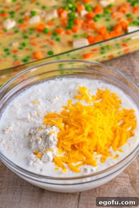 Biscuit mix, cheese and milk in a bowl.