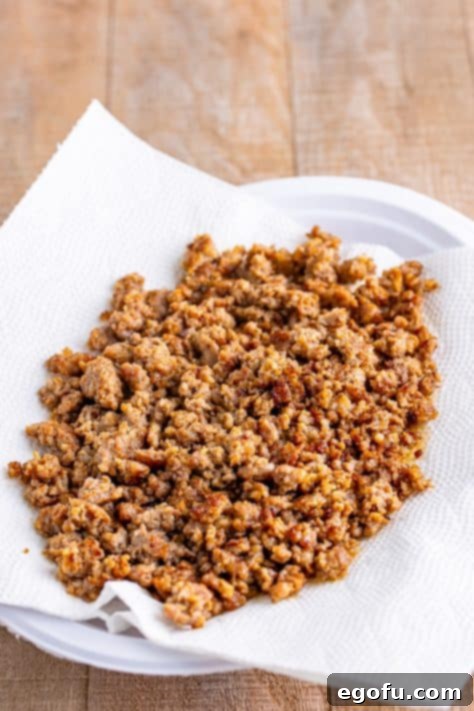 Crumbled sausage on paper towels.