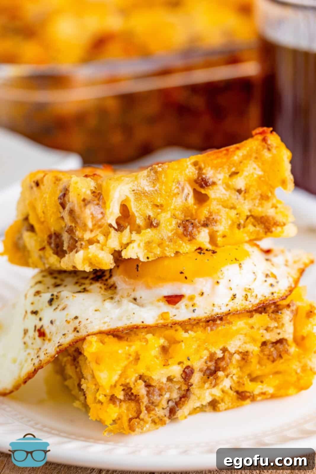 A breakfast butter swim biscuit cut in half with a fried egg in between.