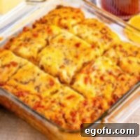 Closely looking at a glass dish of breakfast butter swim biscuits.