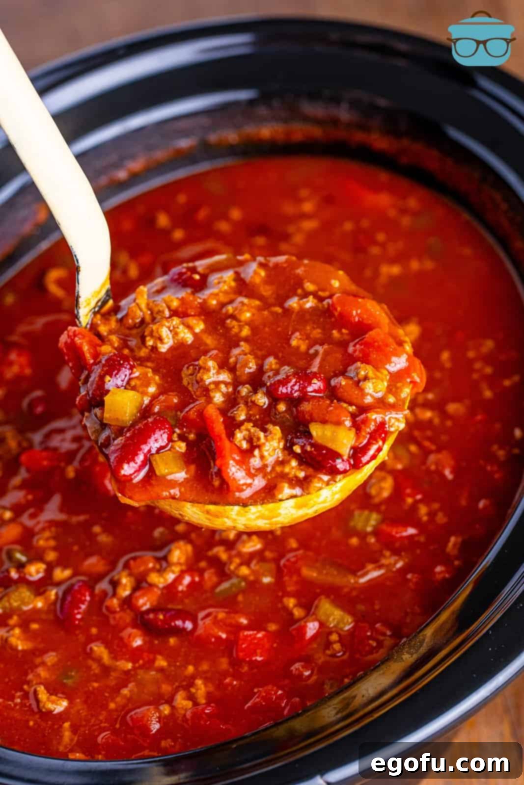 Copycat Wendy's Slow Cooker Chili 7 A ladle holding some Wendy's Chili above the Slow Cooker.