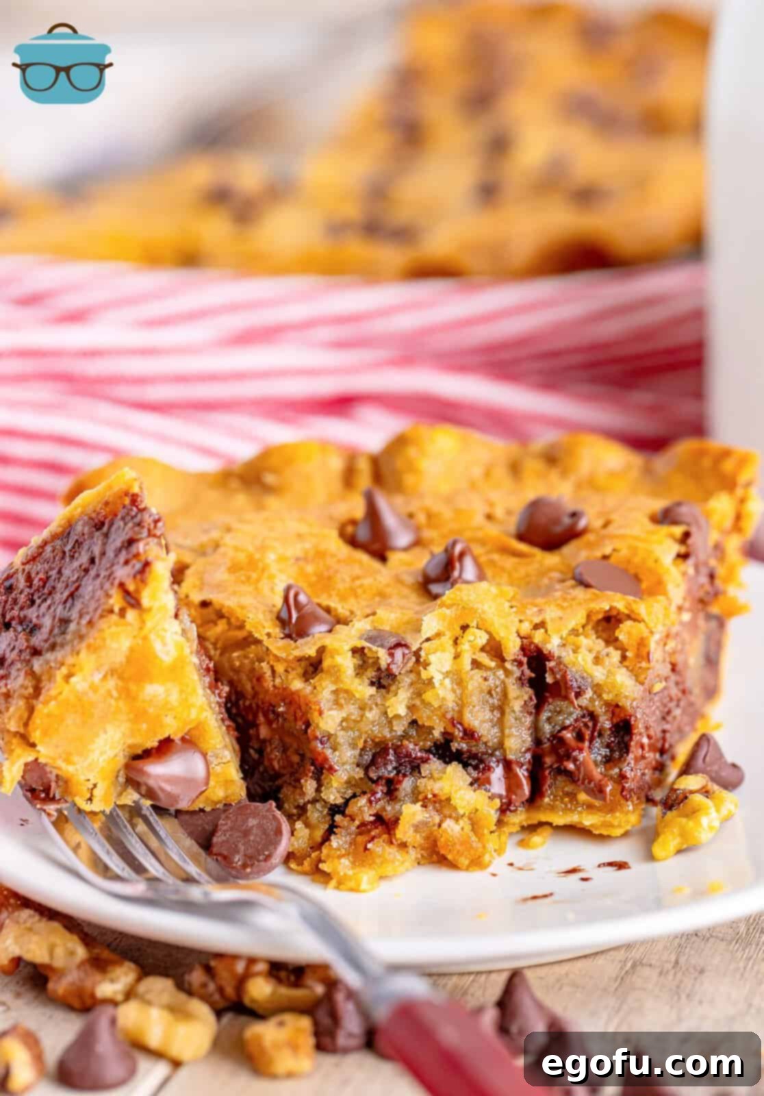 A Tollhouse cookie pie with a fork and a few bites removed.