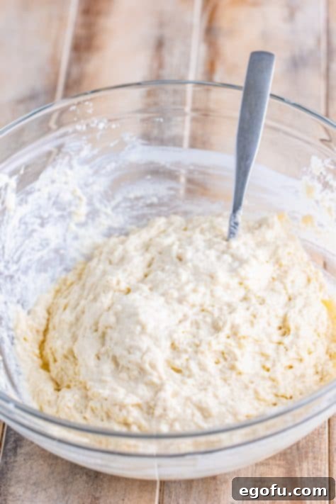 Garlic Butter Bath Biscuits 11 A glass mixing bowl with biscuit batter.
