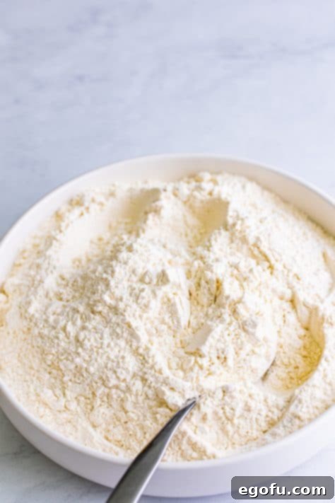 A bowl of all-purpose flour, cream of tartar, baking soda, and salt.