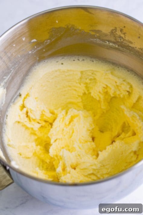 Butter and sugar creamed together in a mixing bowl.