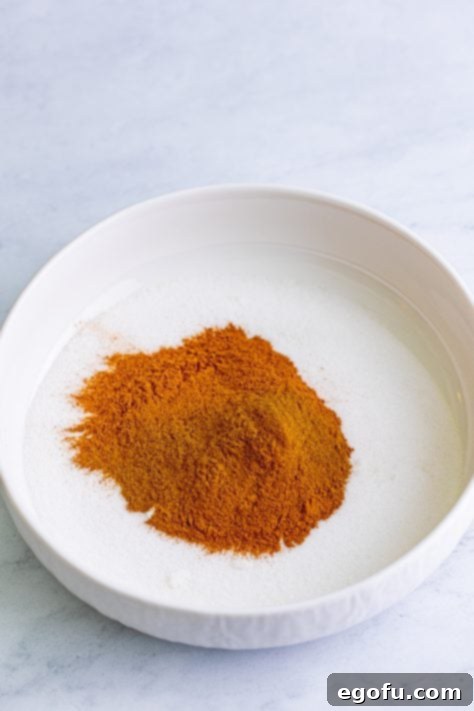 A shallow bowl of cinnamon and sugar.