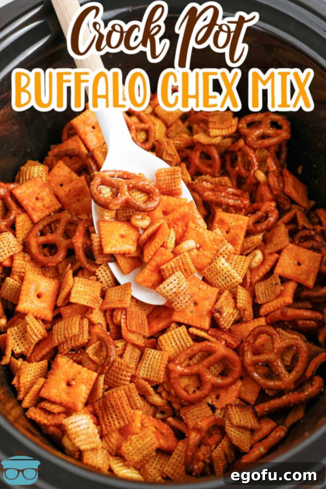 Ultimate Slow Cooker Buffalo Ranch Chex Mix 3 A serving spoon getting a scoop of the delicious Buffalo Ranch Chex Mix from a bowl, ready to be enjoyed.