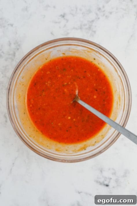 Ultimate Slow Cooker Buffalo Ranch Chex Mix 8 A mixing bowl of melted butter, buffalo sauce and ranch seasoning.