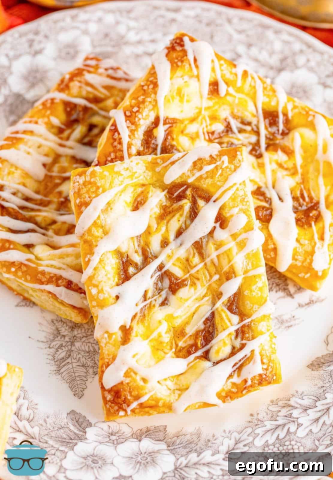 A plate of homemade Pumpkin Danishes, showcasing their golden crust and creamy filling.
