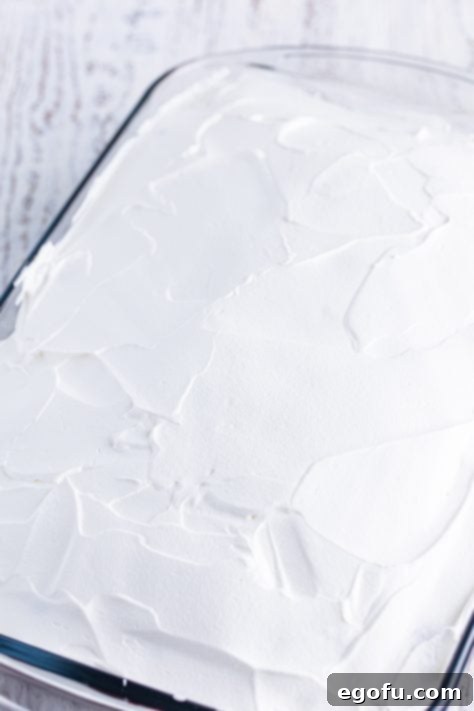 Whipped topping spread on a cake.