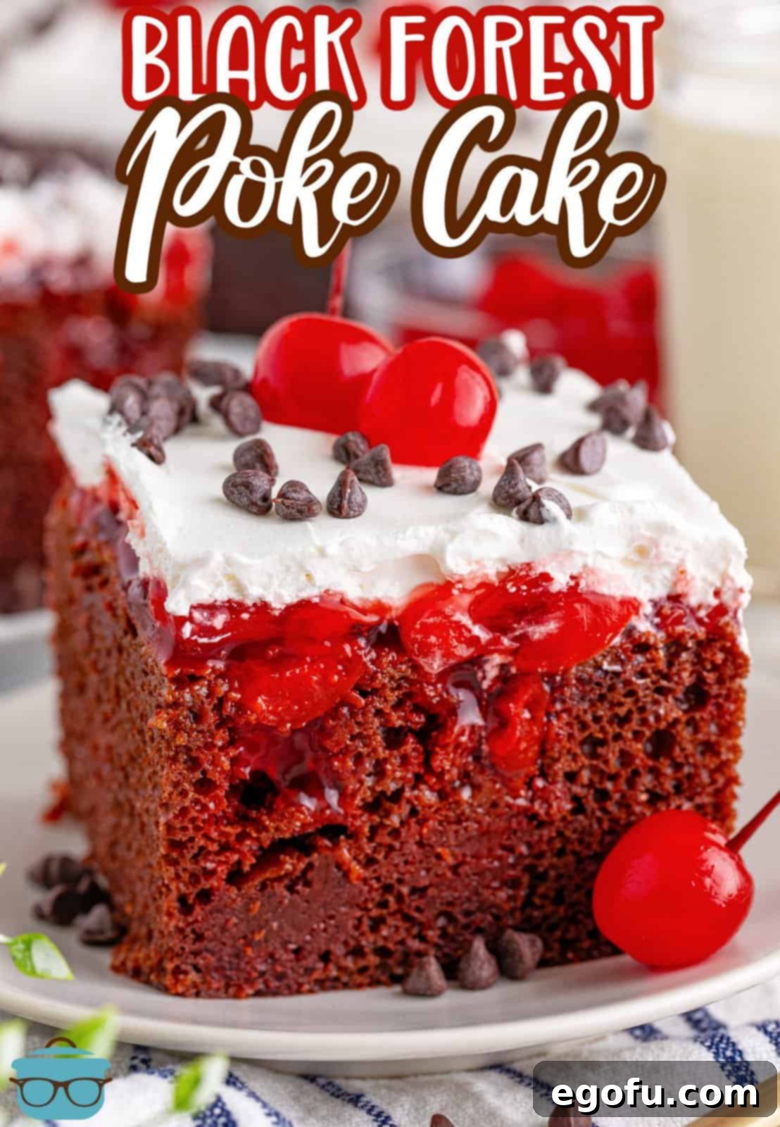 A garnished slice of Black Forest Poke Cake on a plate, ready to be enjoyed.