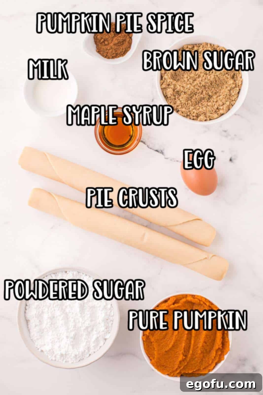 A flat lay photograph showcasing all the essential ingredients for making Pumpkin Pop Tarts: refrigerated pie crusts, light brown sugar, pumpkin puree, egg, pumpkin spice, powdered sugar, milk, and pure maple syrup, neatly arranged for the baking process.