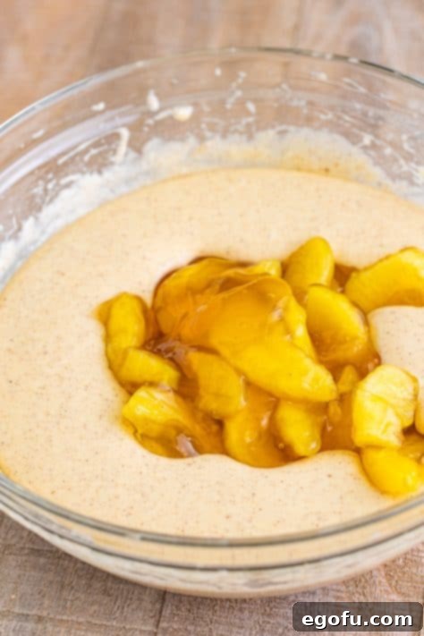 Apple pie filling in a mixing bowl of cake mix.