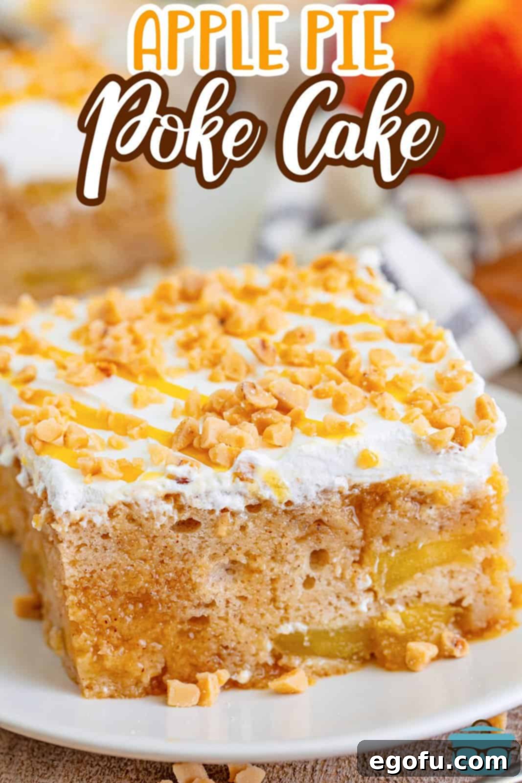 A slice of apple pie poke cake on a white plate.