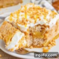 Apple Pie Poke Cake slice on a white plate.