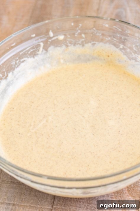 Vanilla cake mix in a bowl with apple spice mix.