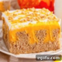 A plate of Pumpkin Poke Cake with perfect fall flavors.