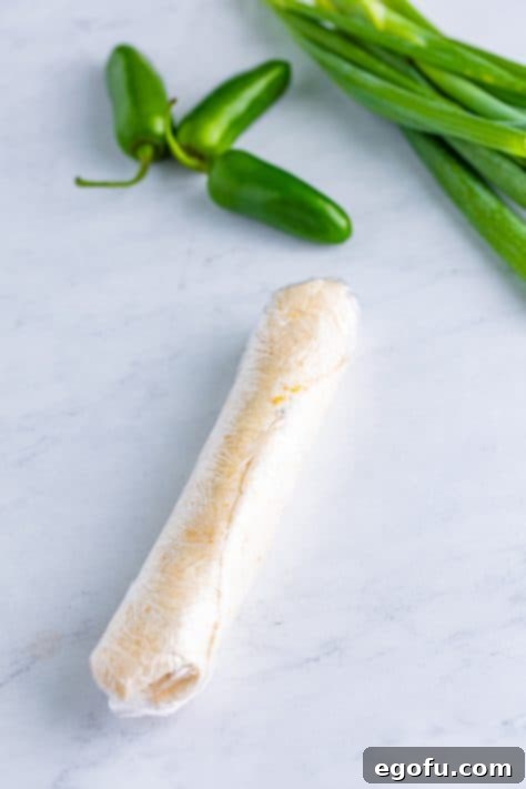 Plastic wrapped Jalapeno Popper Pinwheels that haven't been cut yet.