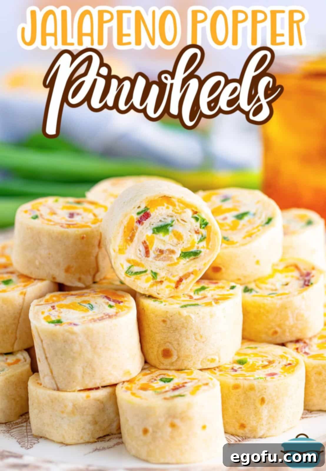 Jalapeno Popper Pinwheels in a pile on a plate.