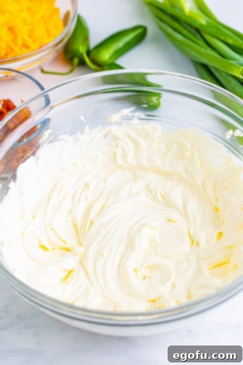 Cream cheese and sour cream in a mixing bowl.