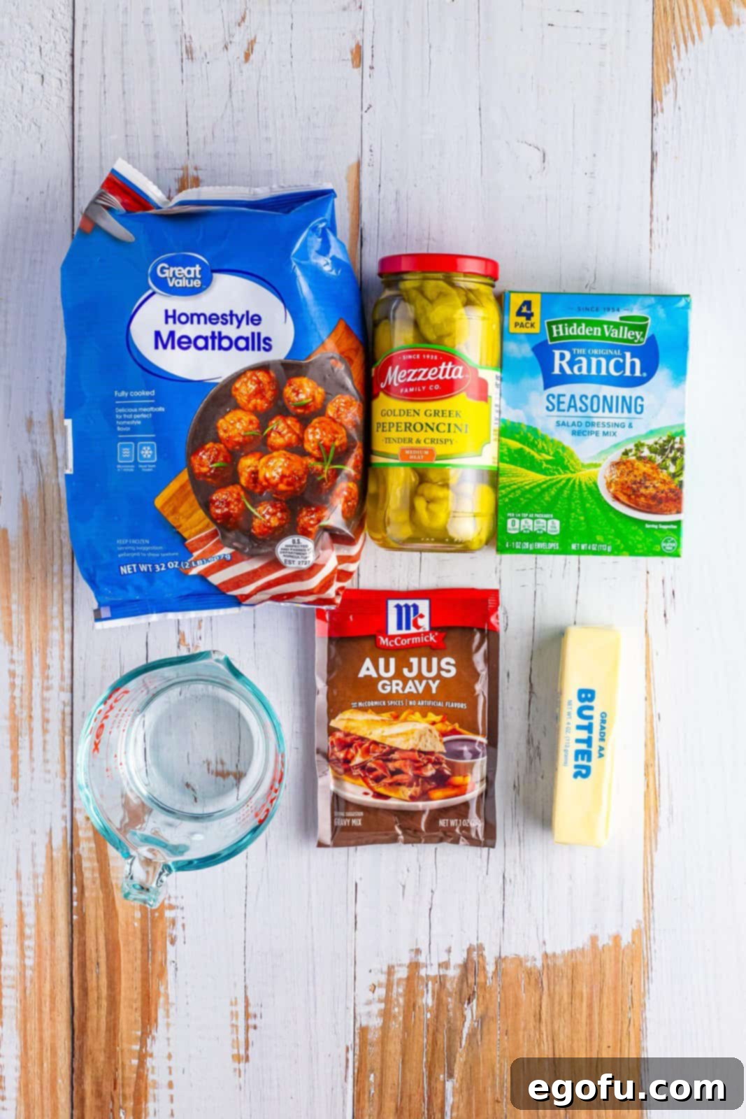 Meatballs, pepperoncinis, ranch seasoning, water, au jus gravy mix, and butter. 