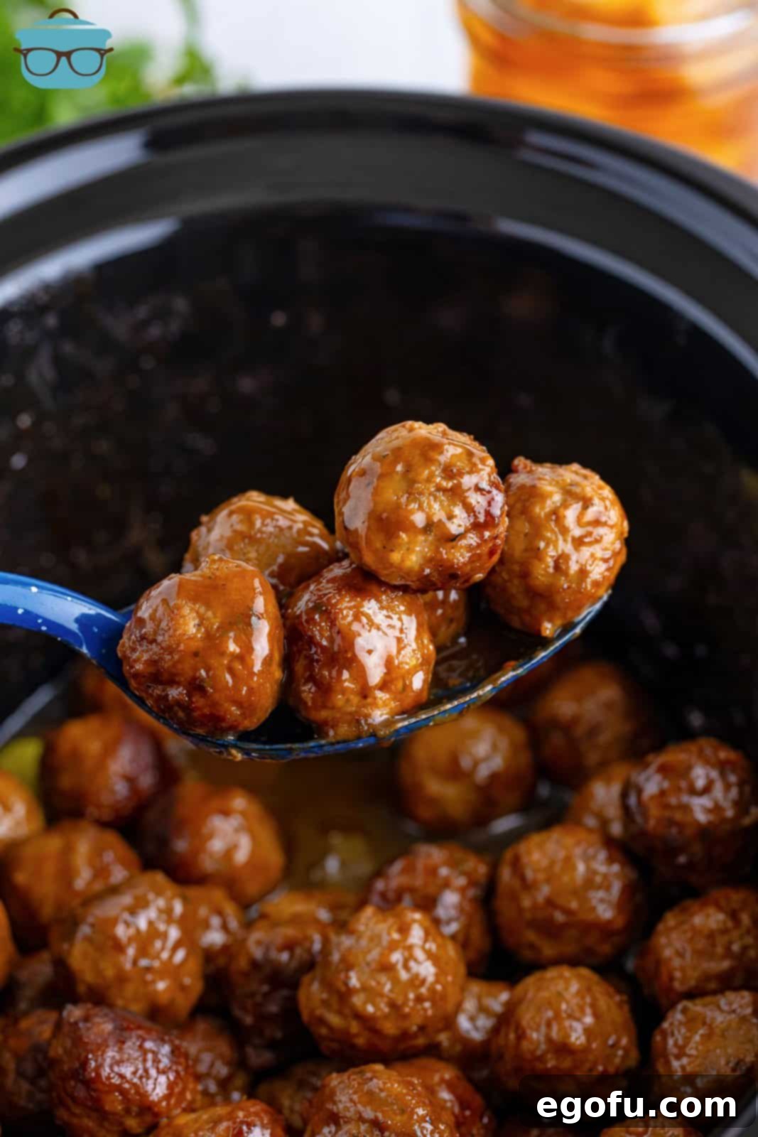 A serving spoon holding some Mississippi Meatballs.
