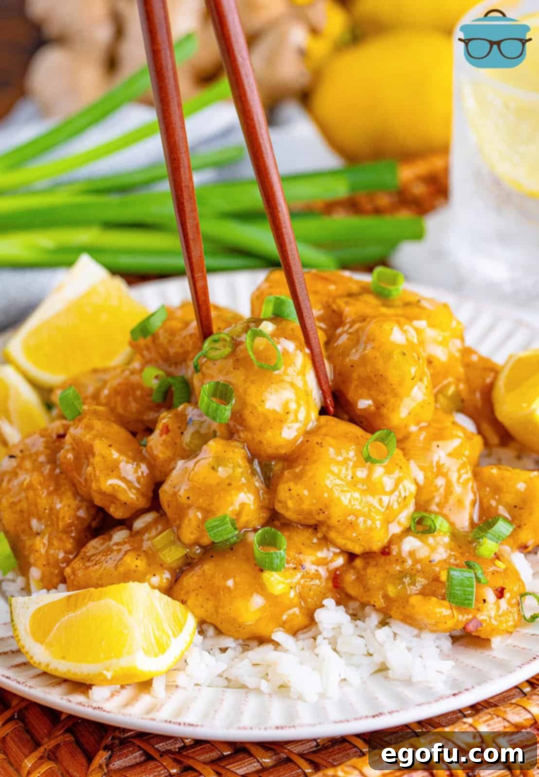Chopsticks in Asian Lemon Chicken on a plate. 