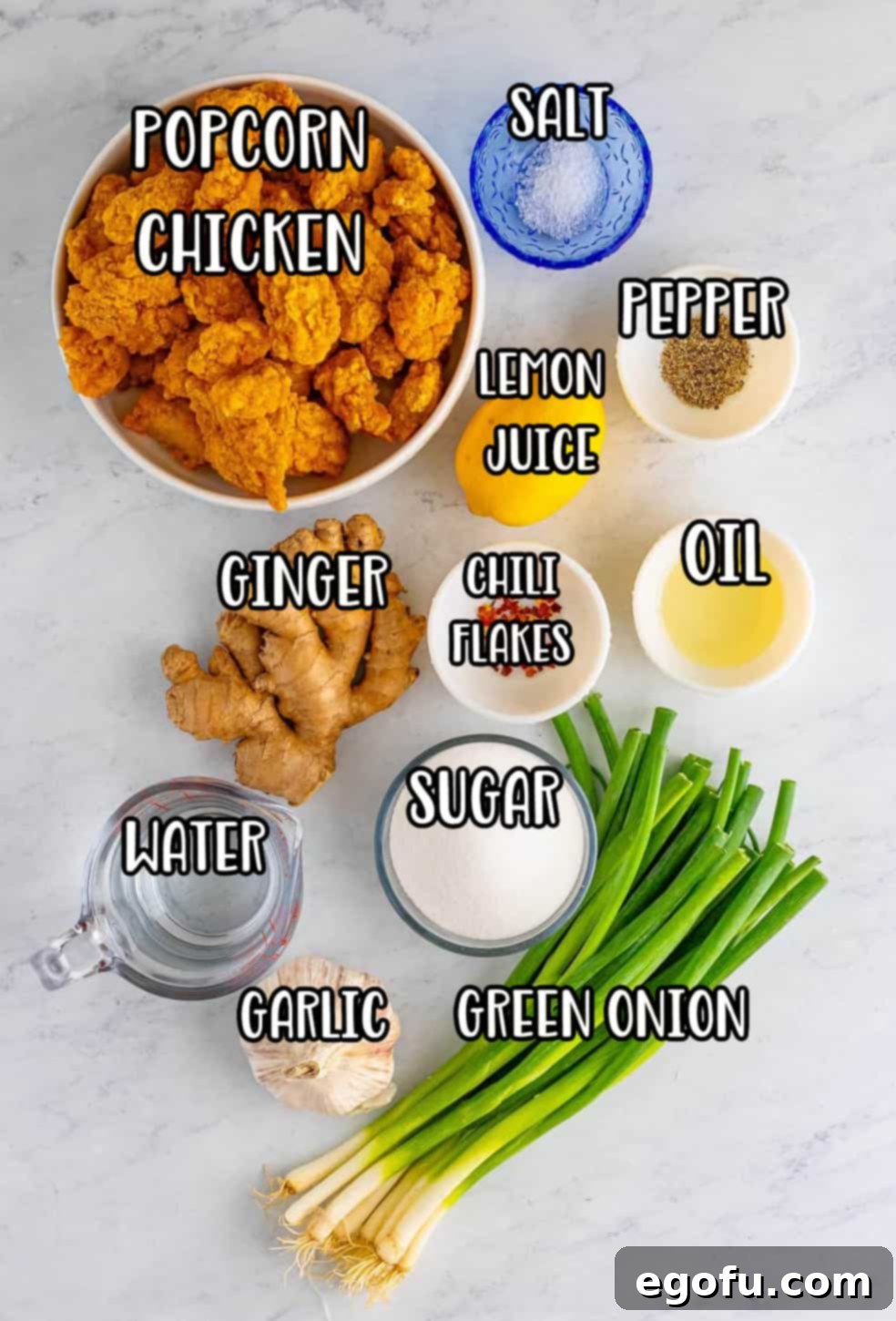 Popcorn chicken, green onion, lemon, kosher salt, black pepper, sugar, water, chili flakes, fresh ginger, fresh garlic, and vegetable oil.