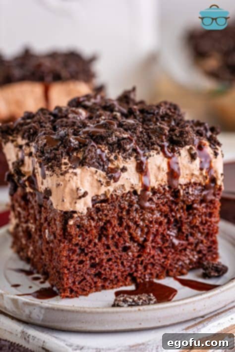 Heavenly Oreo Dream Cake 19 A slice of Oreo Better Than Sex cake sitting on a white plate, ready to be enjoyed.